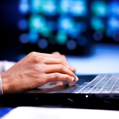 A close up of a person typing on a laptop